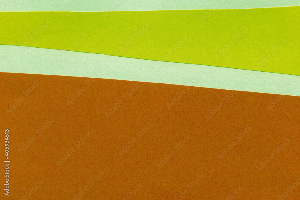 Fototapeta premium Green torn paper collage close-up. Texture made from various paper and cardboard parts. Damaged old paper background. Vintage blank wallpaper. Material design backdrop.