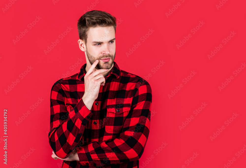 stylish male wear casual clothes. bearded man with bristle on unshaven face. fashion and beauty. barbershop concept. mens wear. young handsome guy in red checkered shirt. copy space