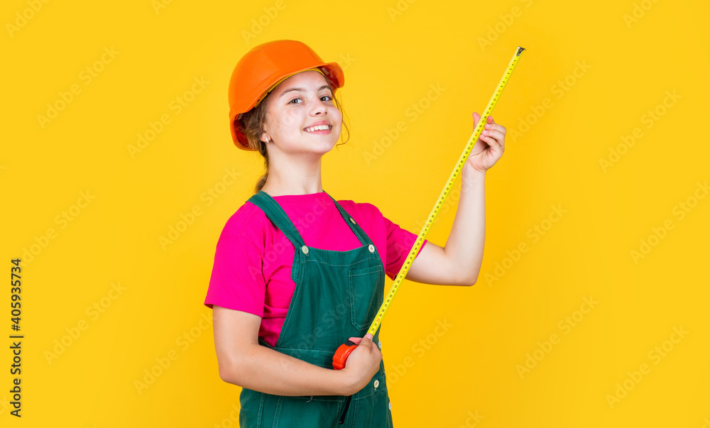 teen girl builder in protective helmet use tape measure, measurement teen girl builder in protective helmet use tape measure, measurement