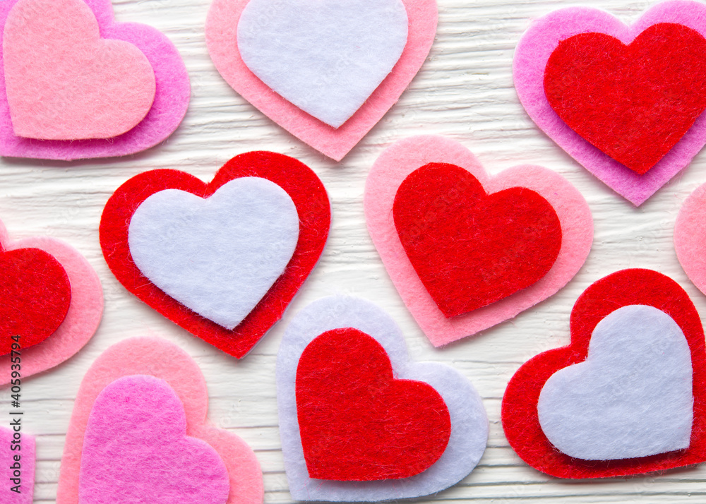 Hearts Valentines day background. Red, pink, purple, white Felt hearts on February 14 Saint Valentine's Day. Decorations greeting card. Love concept. White natural wooden background. High resolution. Hearts Valentines day background. Red, pink, purple, white Felt hearts on February 14 Saint Valentine's Day. Decorations greeting card. Love concept. White natural wooden background. High resolution.