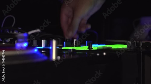 DJ playing and pushing buttons and knobs