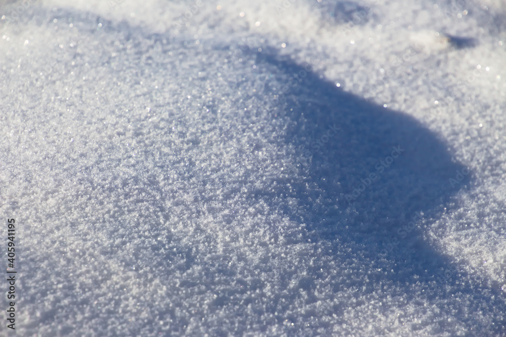 Fresh white snow sparkling in the sun with highlights and shadows for background Fresh white snow sparkling in the sun with highlights and shadows for background
