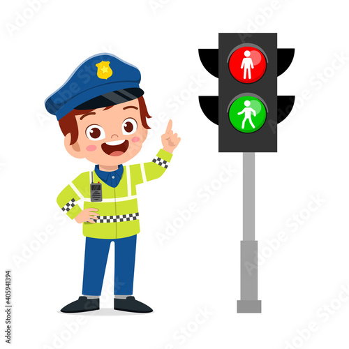 happy cute little kid boy wearing police uniform and stand beside traffic lamp