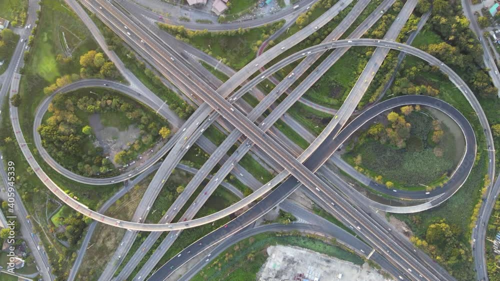 4K. Aerial view of road interchange or highway intersection with busy urban traffic speeding on the road. Junction network of transportation taken by drone. 4K. Aerial view of road interchange or highway intersection with busy urban traffic speeding on the road. Junction network of transportation taken by drone.