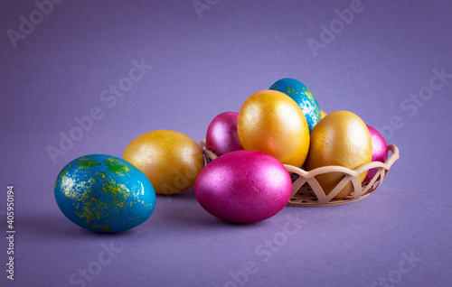Bright colored eggs on a gray background. Easter theme, holiday. Happy easter card with copy space for text in minimalist easter style. Color of the year. Grey.