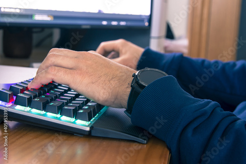 Selective focus shot of a man working on the computer from home - concept of new normal photo