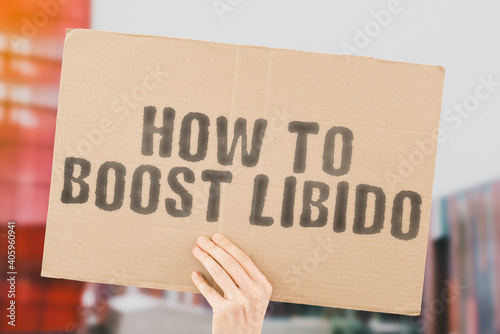 Fényképezés The phrase  How to boost libido  on a banner in men's hand with blurred background