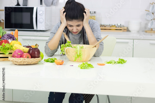 Asian young woman Cooking in the kitchen.With stress