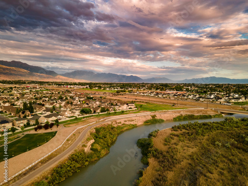 Colorful sunset clouds over an urban area and river - aerial view