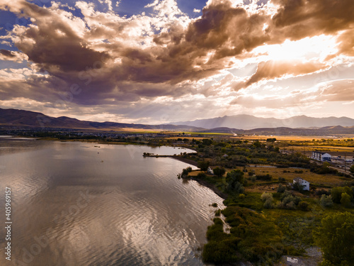 Aerial view of a lake with dramatic clouds overhead