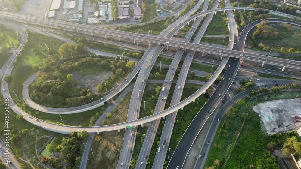 4K. Aerial view of road interchange or highway intersection with busy urban traffic speeding on the road. Junction network of transportation taken by drone. 4K. Aerial view of road interchange or highway intersection with busy urban traffic speeding on the road. Junction network of transportation taken by drone.