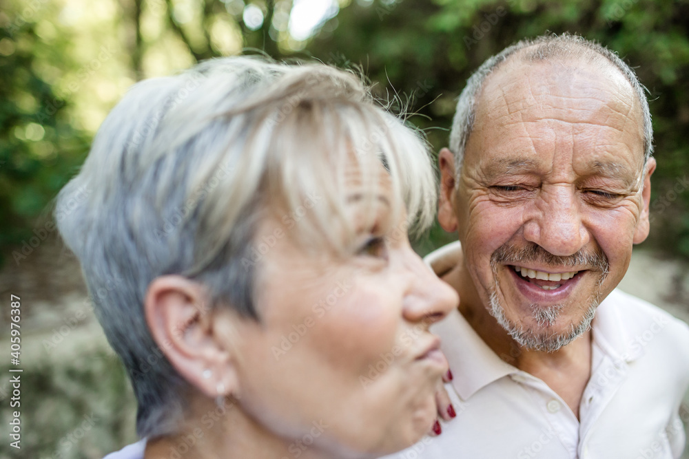 Senior couple in love and very happy enjoying a walk in the field at sunset Senior couple in love and very happy enjoying a walk in the field at sunset