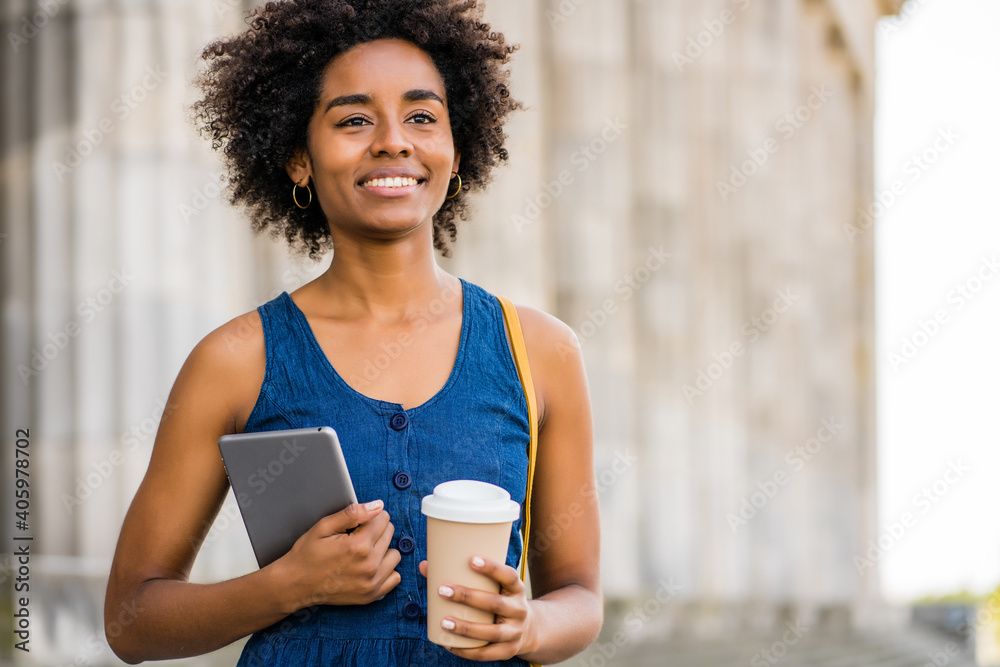 Business woman holding digital tablet and coffee outdoors. Business woman holding digital tablet and coffee outdoors.