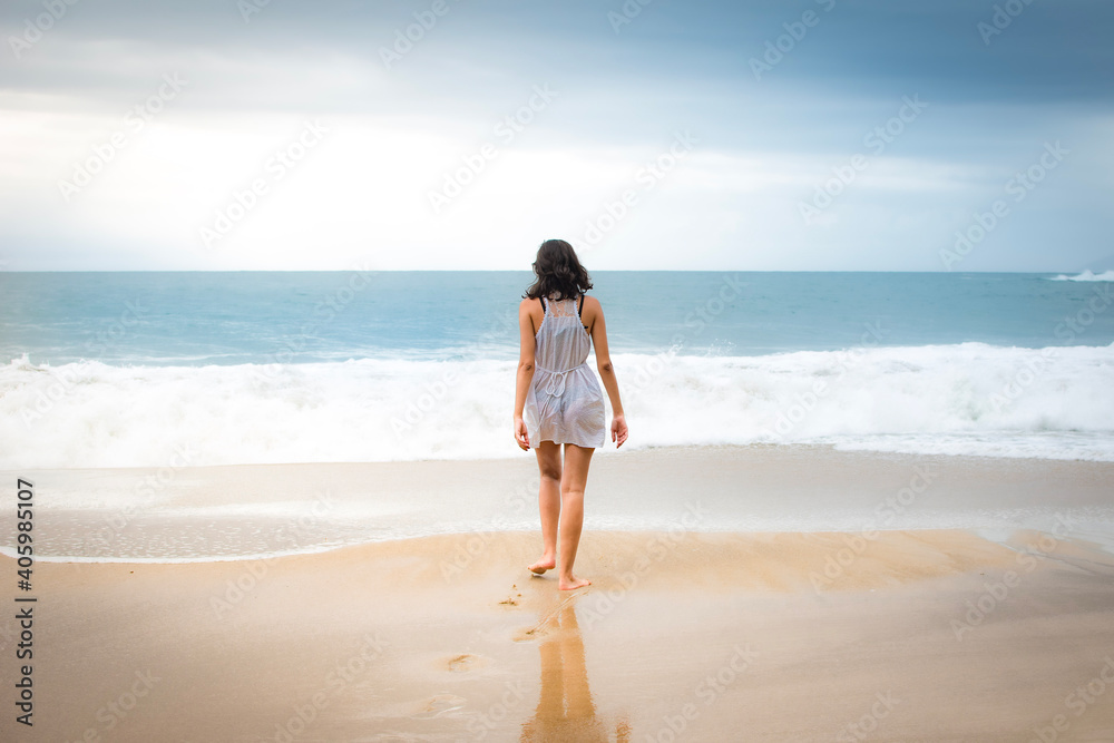 person walking on the beach