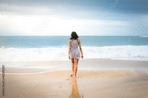 person walking on the beach © Rodolfo