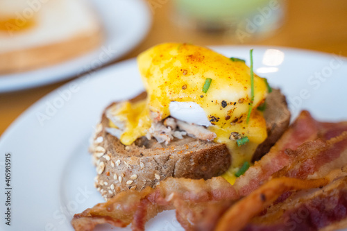 egg benedict with crispy bacon for breakfast