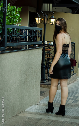 Girl walking in protective mask on the street photo