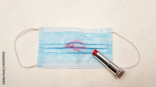 Foto Blue medical mask and red lipstick isolated on white background