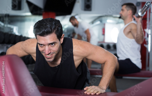 Muscular man practicing healthy lifestyle, performing push-ups during training