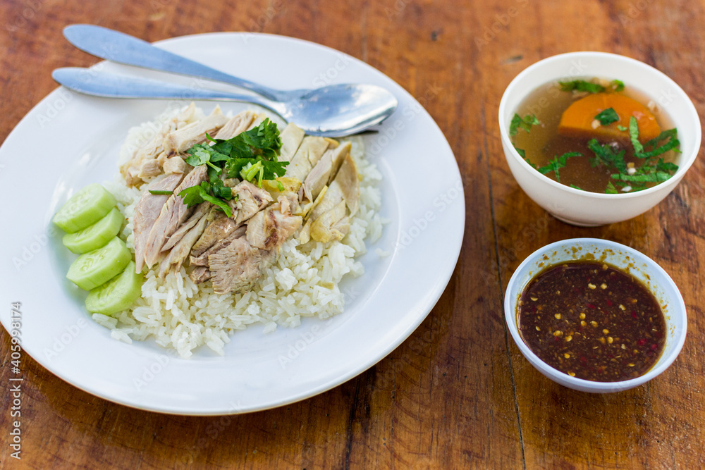 Thai Khao Man Gai, rice with chicken at street restaurant. Street food in Sukhothai, Thailand.