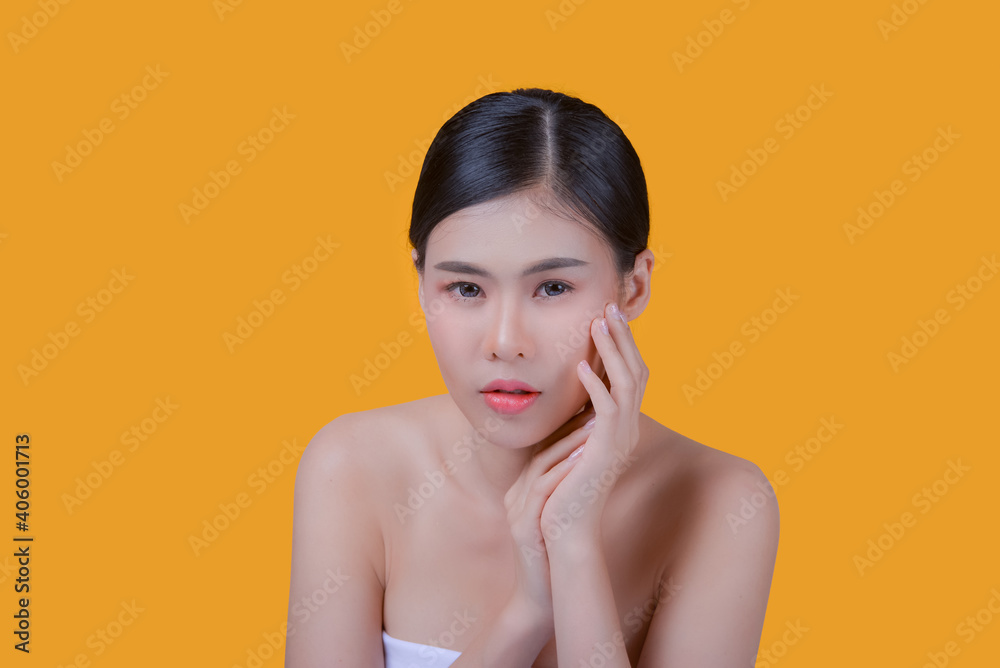 Beauty Spa Woman with perfect skin Portrait. Asian beautiful woman skin makeup young model, on yellow in studio Beauty Spa Woman with perfect skin Portrait. Asian beautiful woman skin makeup young model, on yellow in studio