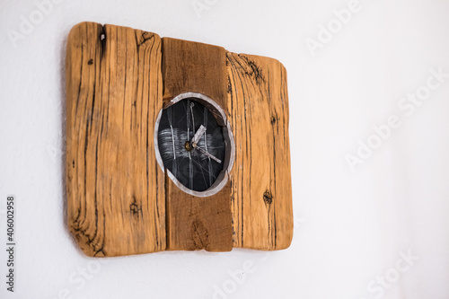 Closeup shot of an old wooden wall clock isolated on white background