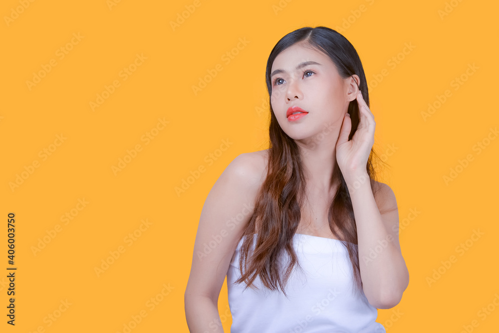 Beauty and healthcare. Portrait of young and beautiful asian woman on yellow background