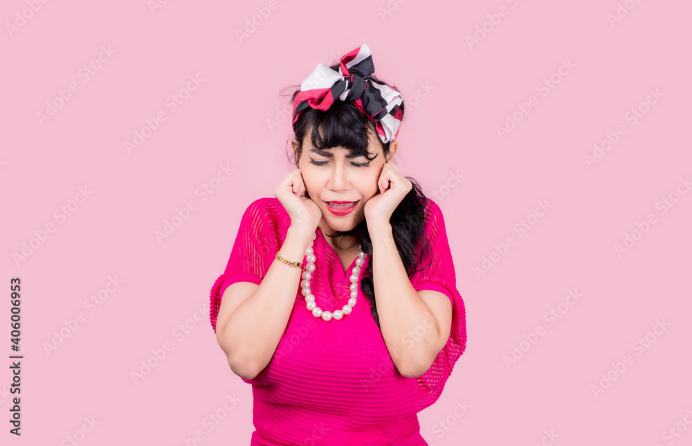Attractive energetic Asian woman happy isolated on pink studio background.Retro vintage 50's style Emotion face expressi