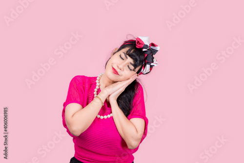 Attractive energetic Asian woman happy isolated on pink studio background.Retro vintage 50's style Emotion face expressi © NITIKAN T.
