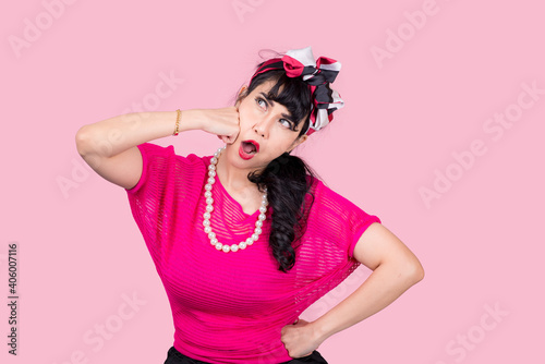 Attractive energetic Asian woman happy isolated on pink studio background.Retro vintage 50's style Emotion face expressi