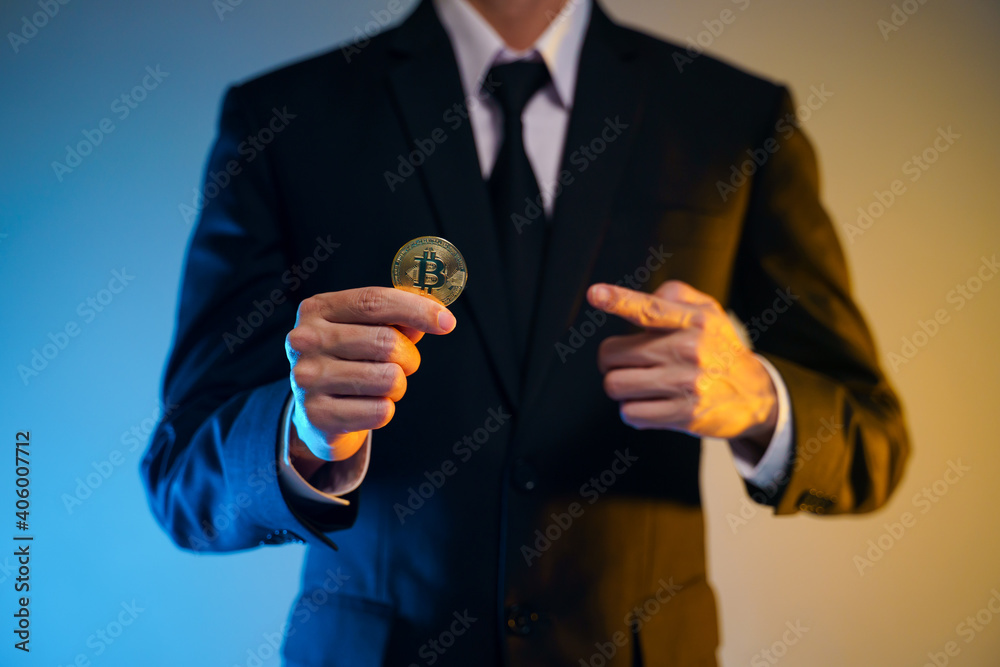Close up shot of Businessman holding golden coin. Close up shot of Businessman holding golden coin.