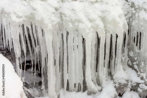 Icicles and frost on a snow-covered frozen river © Александр Коликов