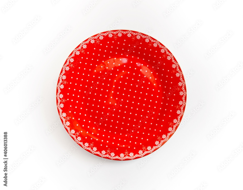 Red dessert ceramic plate with white pattern closeup on white background