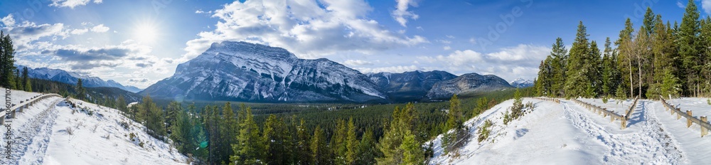 Banff National Park beautiful mountain landscape. Panorama view Mount Rundle valley forest and Bow River in snowy autumn sunny day. Hoodoos Viewpoint, Canadian Rockies.