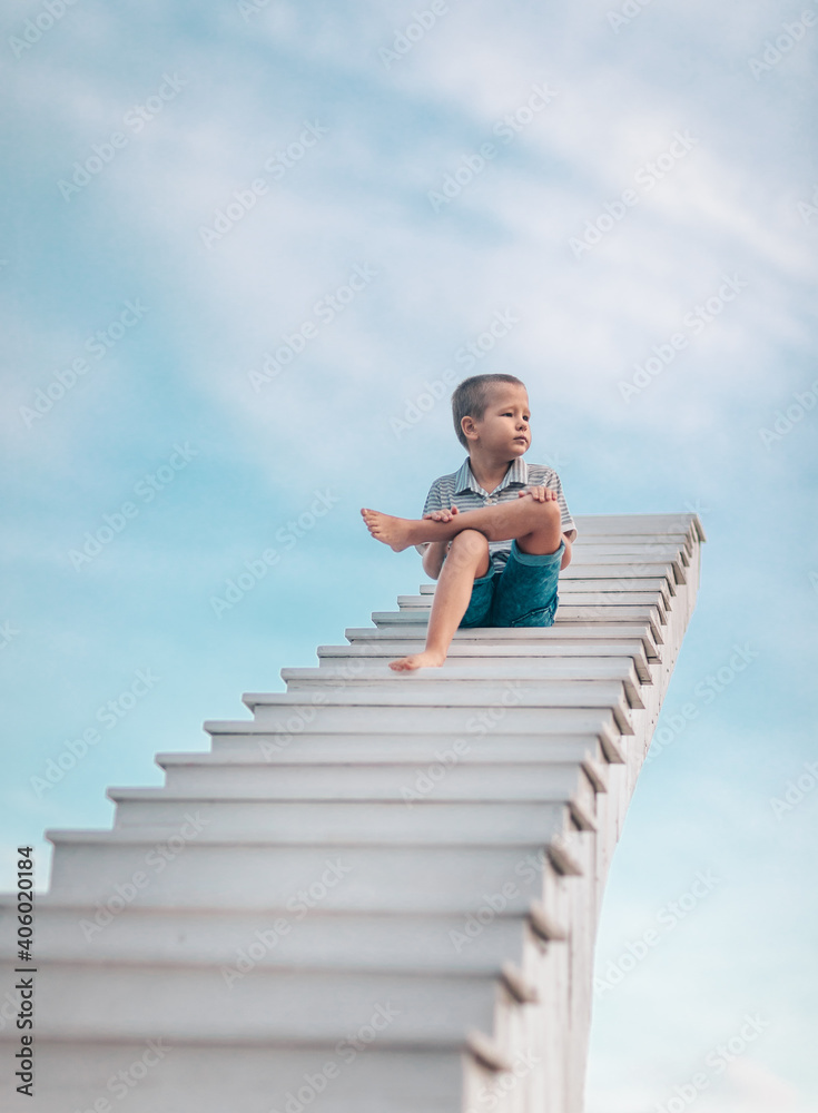 Boy on the stairs to sky