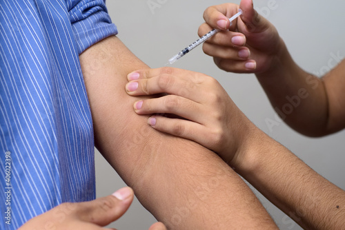 Medical worker injecting insulin dose to the patient photo