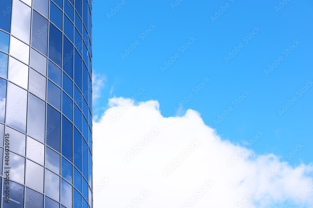 Architectural detail of the facade with multiple reflections of other buildings and the sun. Modern building. Architecture background Architectural detail of the facade with multiple reflections of other buildings and the sun. Modern building. Architecture background