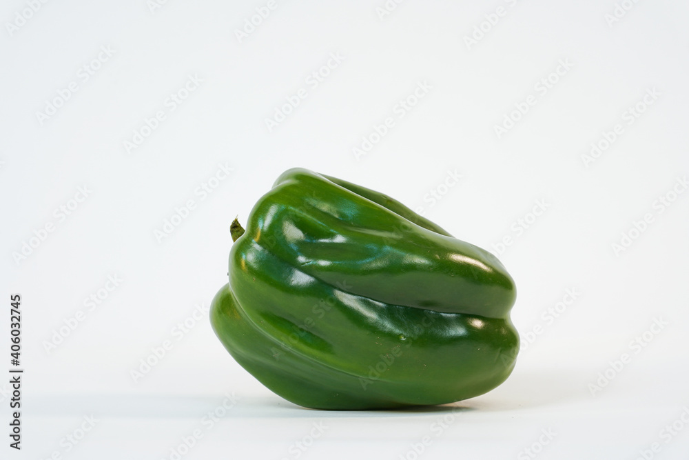 Green bell pepper. Fresh green sweet pepper on white. Food Concept. Product for sale. Studio photo. Copy space. Green bell pepper. Fresh green sweet pepper on white. Food Concept. Product for sale. Studio photo. Copy space.