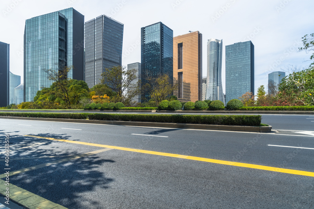 cityscape and skyline of hangzhou from empty asphalt road