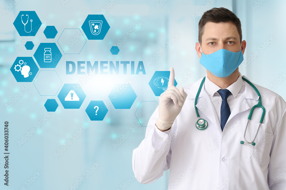 Male neurologist with protective medical mask using virtual screen in clinic. Concept of dementia Male neurologist with protective medical mask using virtual screen in clinic. Concept of dementia