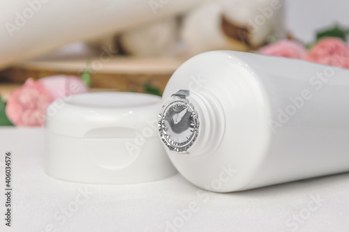 Not opened white tube of cream or lotion with aluminum foil protection cover. Cosmetic product concept