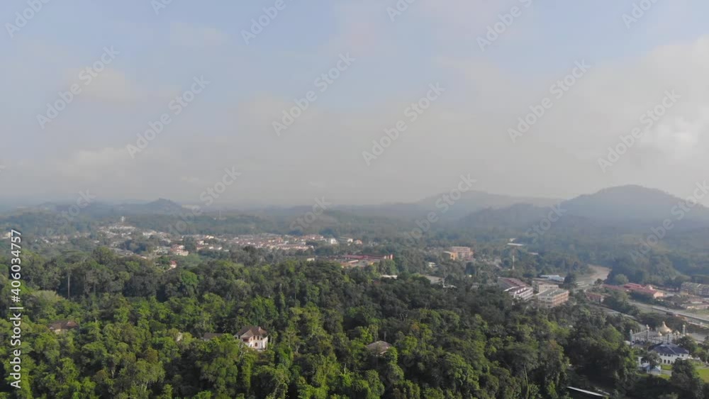 Aerial View Of Peaceful Green Lands With Mountains In The Background On A Clear Day - Pan Left To Right Aerial View Of Peaceful Green Lands With Mountains In The Background On A Clear Day - Pan Left To Right