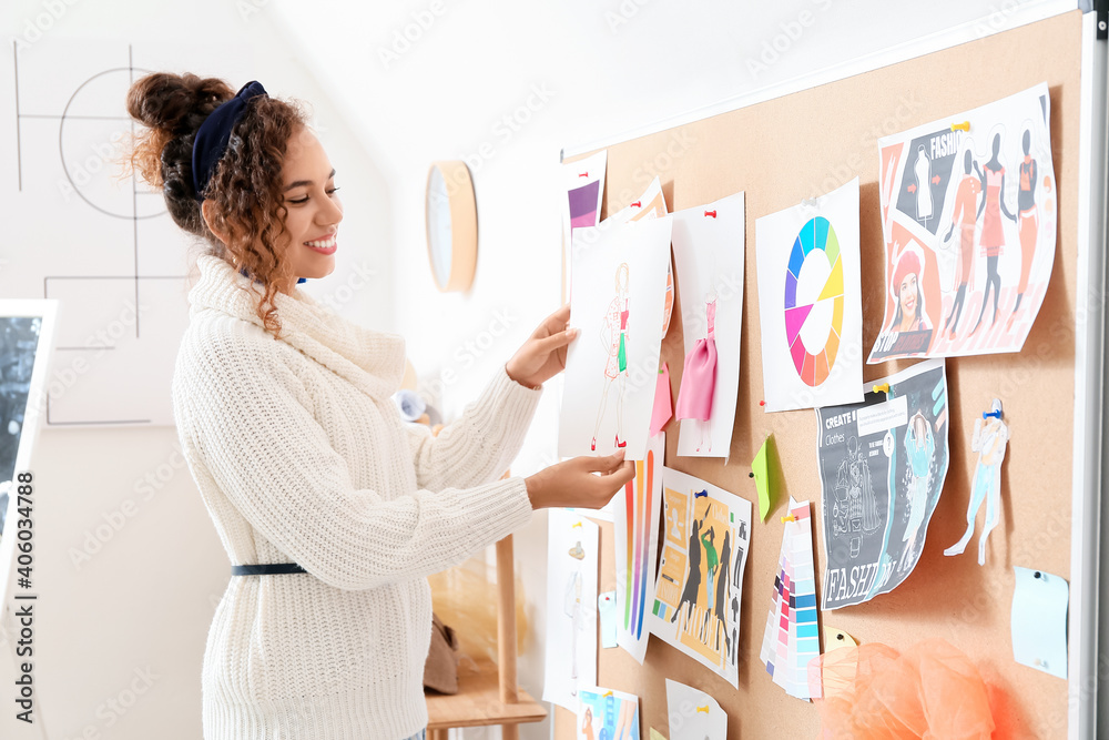 Female fashion designer working in studio Female fashion designer working in studio