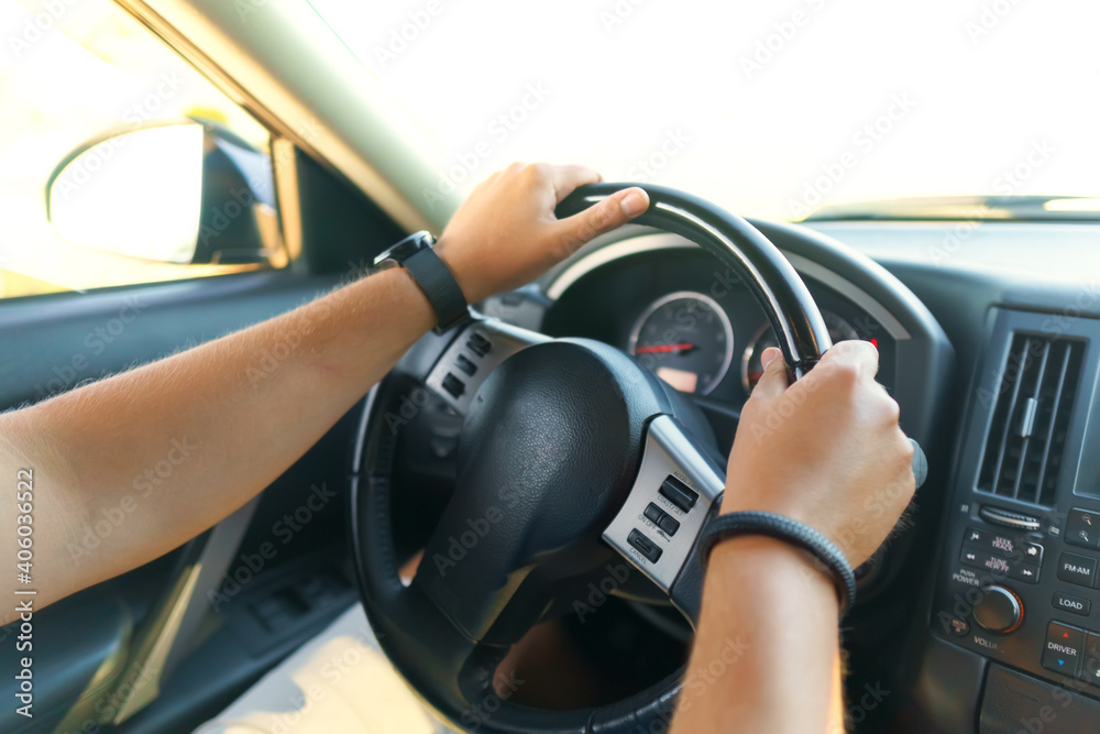 Driver's hands on a steering wheel Driver's hands on a steering wheel