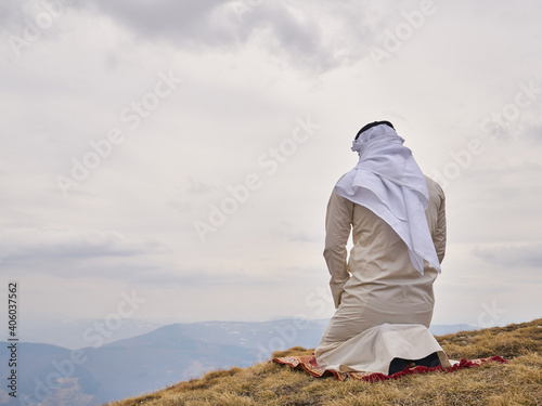 A muslim person pray in the mountains