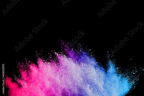 Explosion of colored powder on black background.