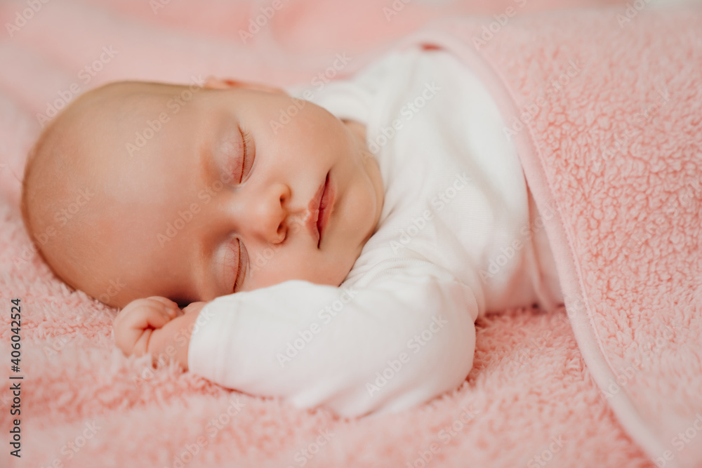 sleeping baby under the pink blanket. healthy sleep in newborns. sleeping baby under the pink blanket. healthy sleep in newborns.