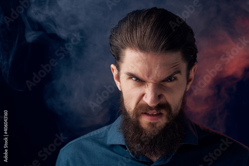 Emotional bearded man angry look shirt smoke in the background