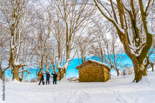 Hikers next to the beautiful refuge among giant trees in the Oianleku natural park in the town of Oiartzun along Peñas de Aya, Gipuzkoa. Basque Country photo