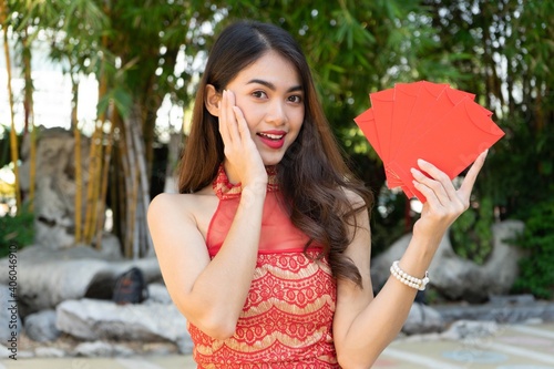 Asian woman holding red envelopes Ang Pao Chinese Happy new year